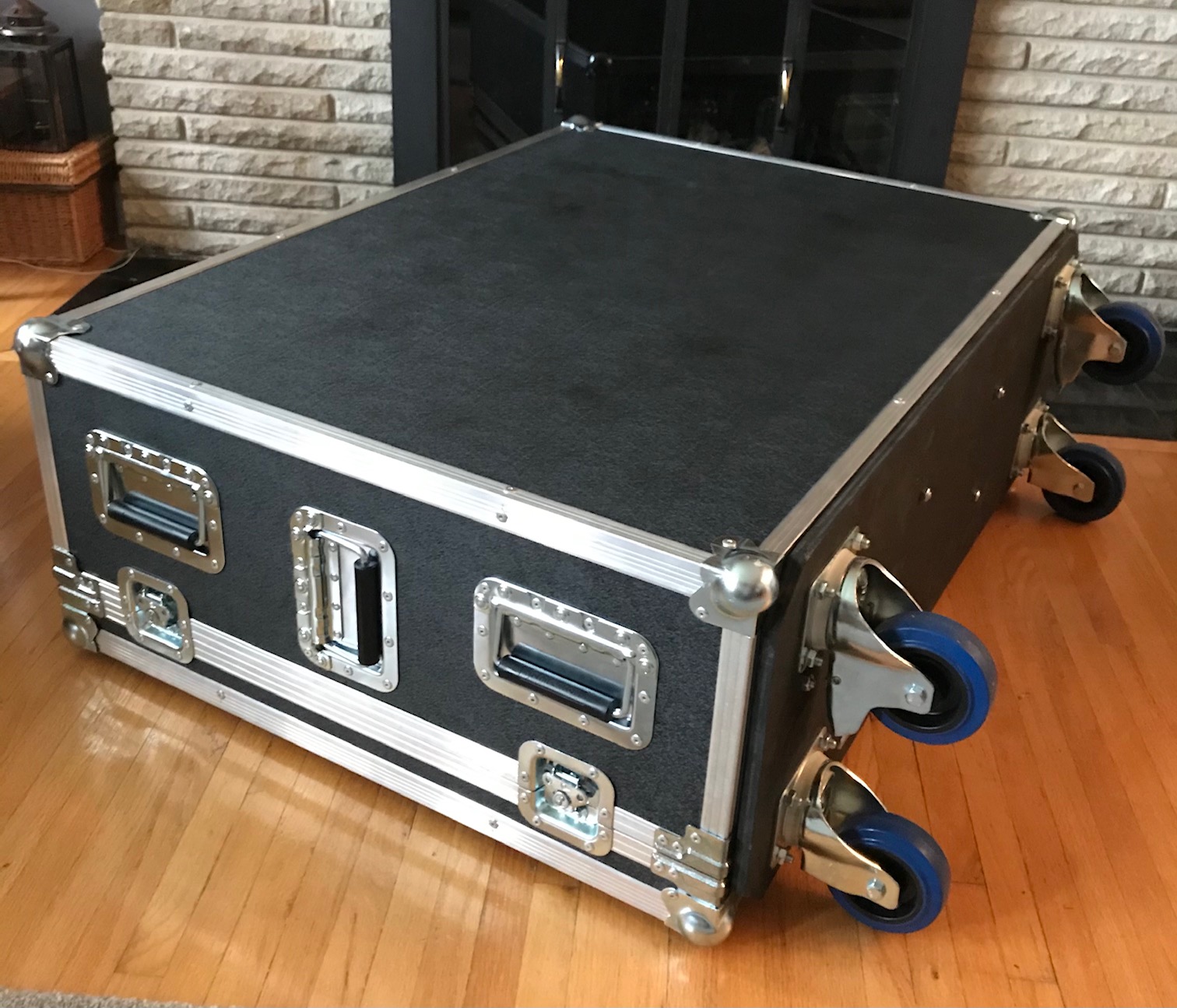 road case on side with blue wheels